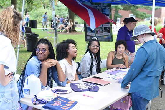 Photo of Chatham University students at a club table during activities fair