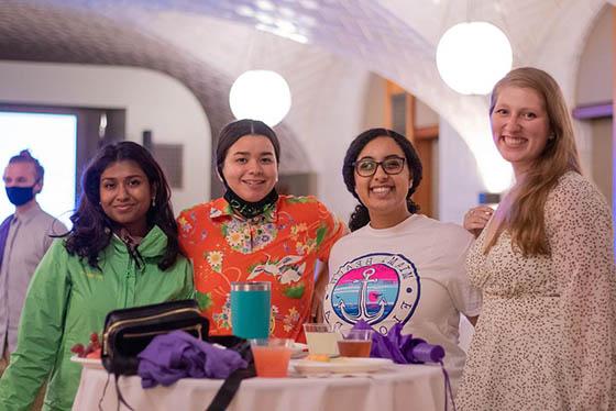 Photo of four Chatham University graduate students posing together for a photo at a welcome event